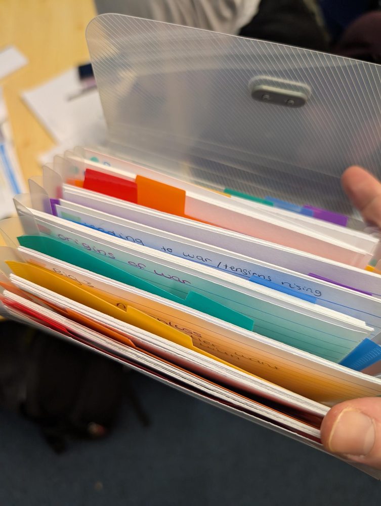 Colour-coded flashcards organised by topic in a file